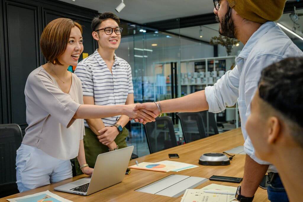 a group of business professionals shaking hands
